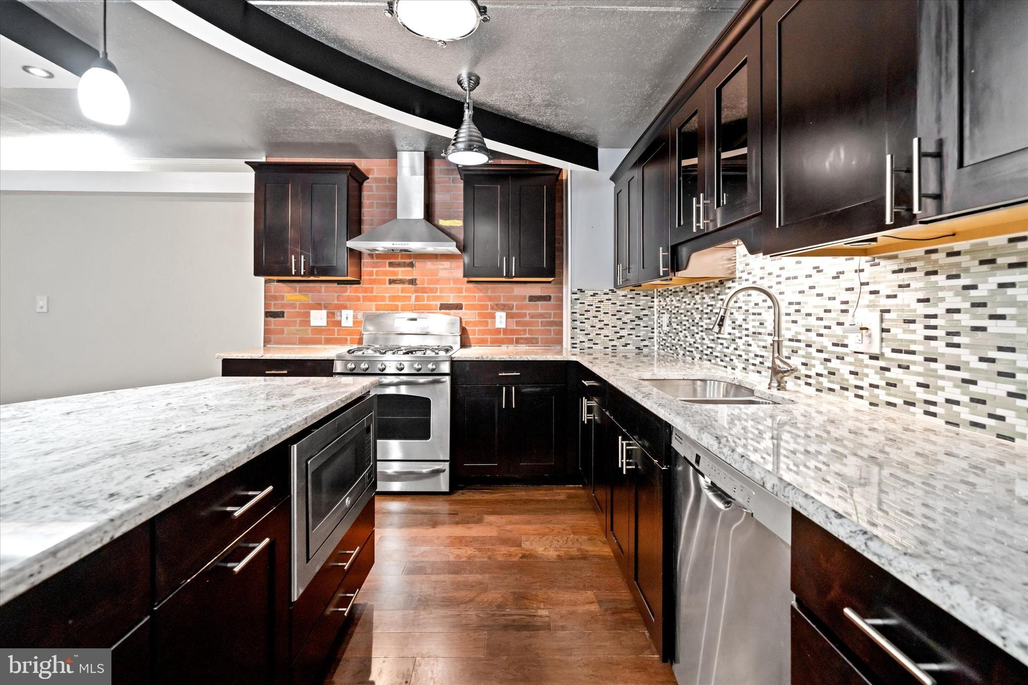 80 Welsh Tract Road, Unit G209 Newark, DE 19713 - Photo 6 of 26 a kitchen with stainless steel appliances granite countertop counter space a stove and cabinets