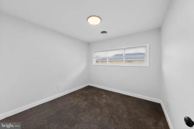 an empty room with a empty space and windows