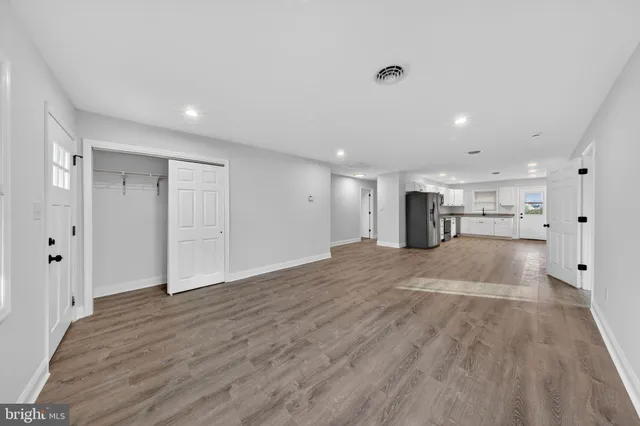 a view of empty room with wooden floor