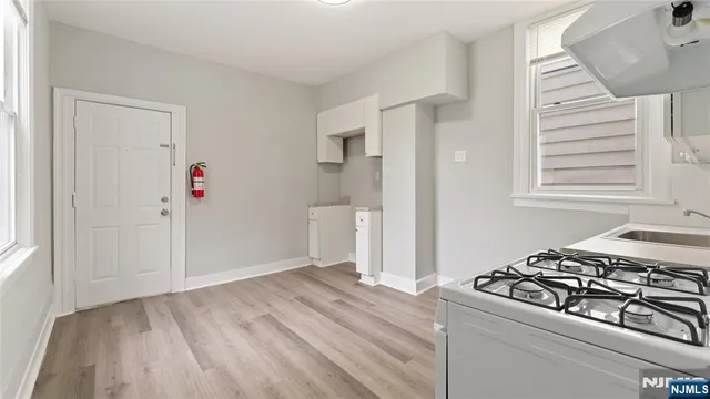 a view of a livingroom with wooden floor and entryway