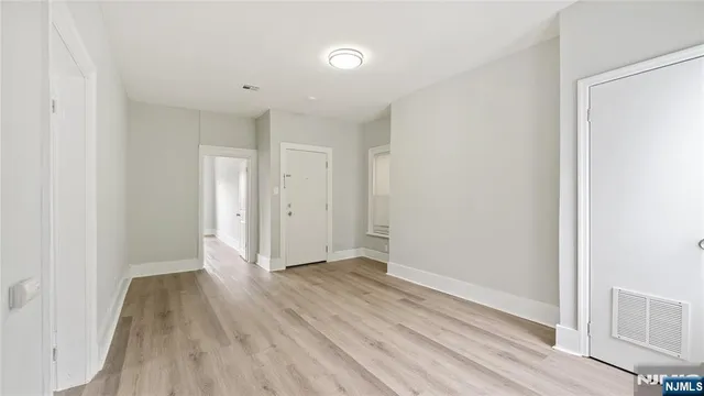 a view of hallway with wooden floor
