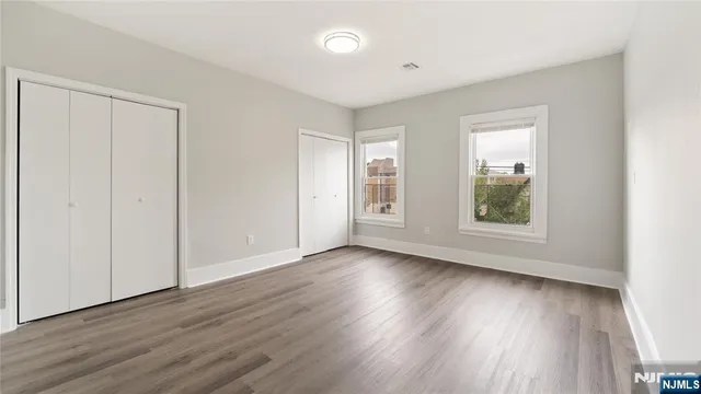 a view of a hallway with wooden floor and a fireplace