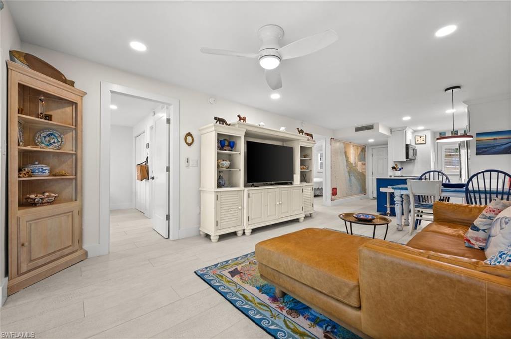 1021 3rd Street South, Unit 112 Naples, FL 34102 - Photo 12 of 27 a living room with furniture and a flat screen tv
