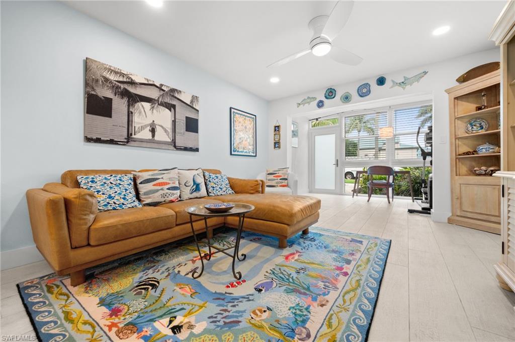 1021 3rd Street South, Unit 112 Naples, FL 34102 - Photo 13 of 27 a living room with furniture and wooden floor