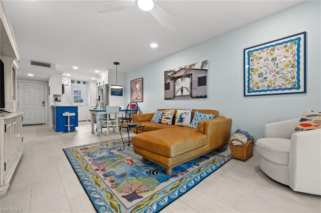 1021 3rd Street South, Unit 112 Naples, FL 34102 - Photo 14 of 27 a living room with furniture and a table