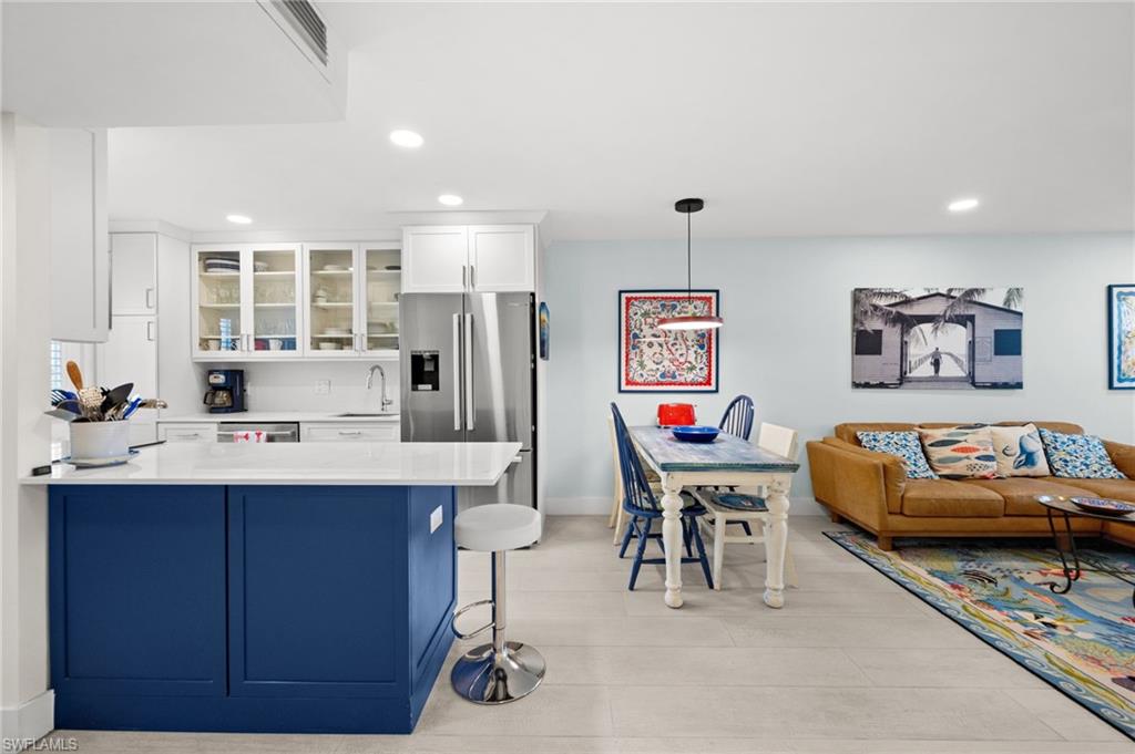 1021 3rd Street South, Unit 112 Naples, FL 34102 - Photo 15 of 27 a living room with furniture and kitchen view
