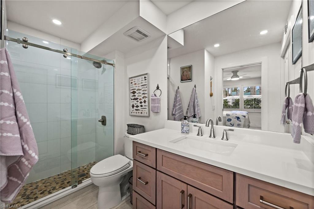 1021 3rd Street South, Unit 112 Naples, FL 34102 - Photo 18 of 27 a bathroom with a sink toilet and shower