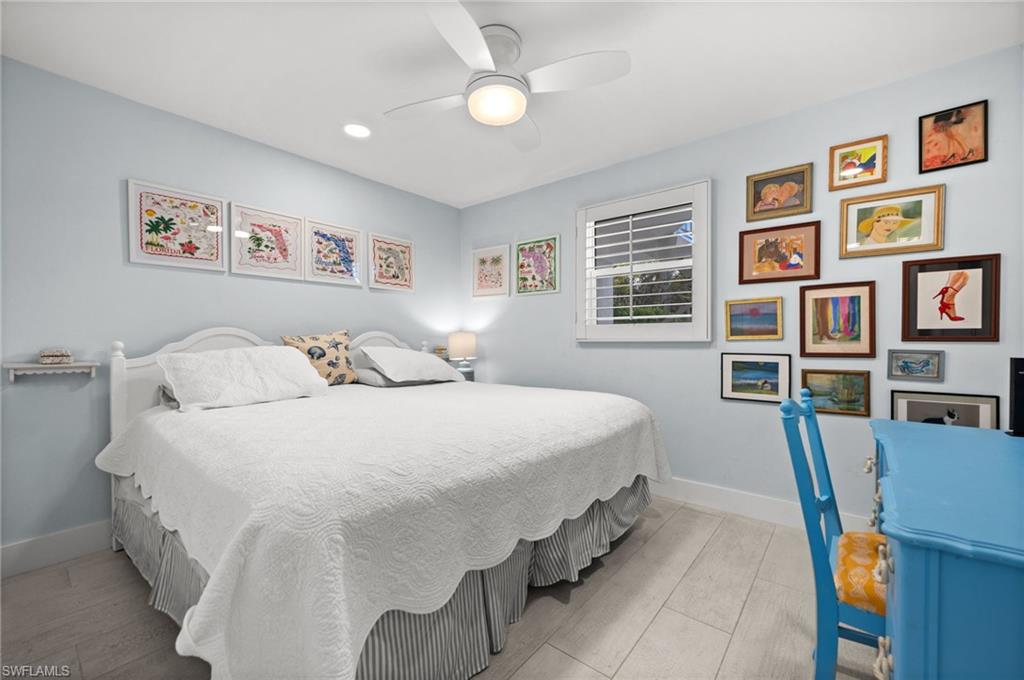 1021 3rd Street South, Unit 112 Naples, FL 34102 - Photo 20 of 27 a spacious bedroom with a bed and a cabinets