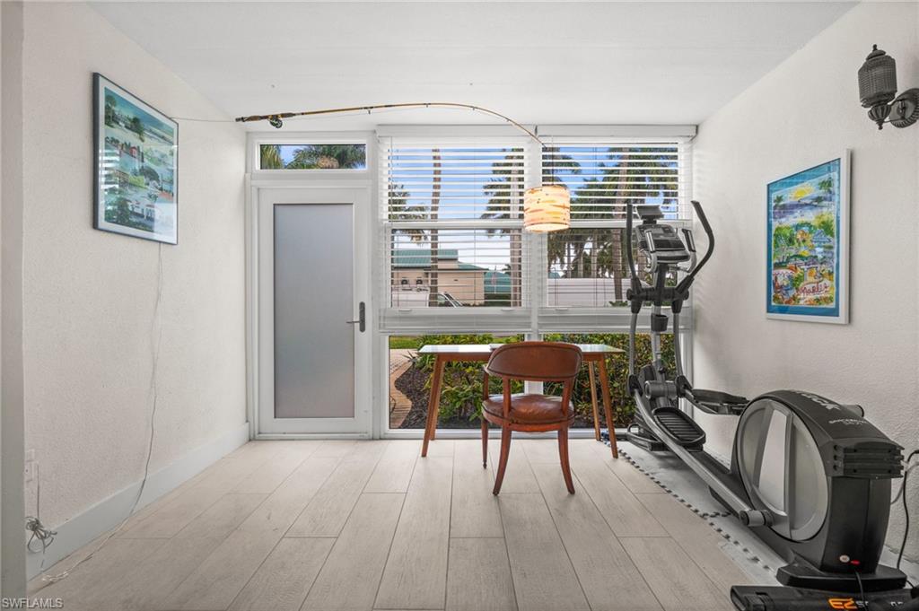 1021 3rd Street South, Unit 112 Naples, FL 34102 - Photo 23 of 27 a view of a room with furniture wooden floor and windows