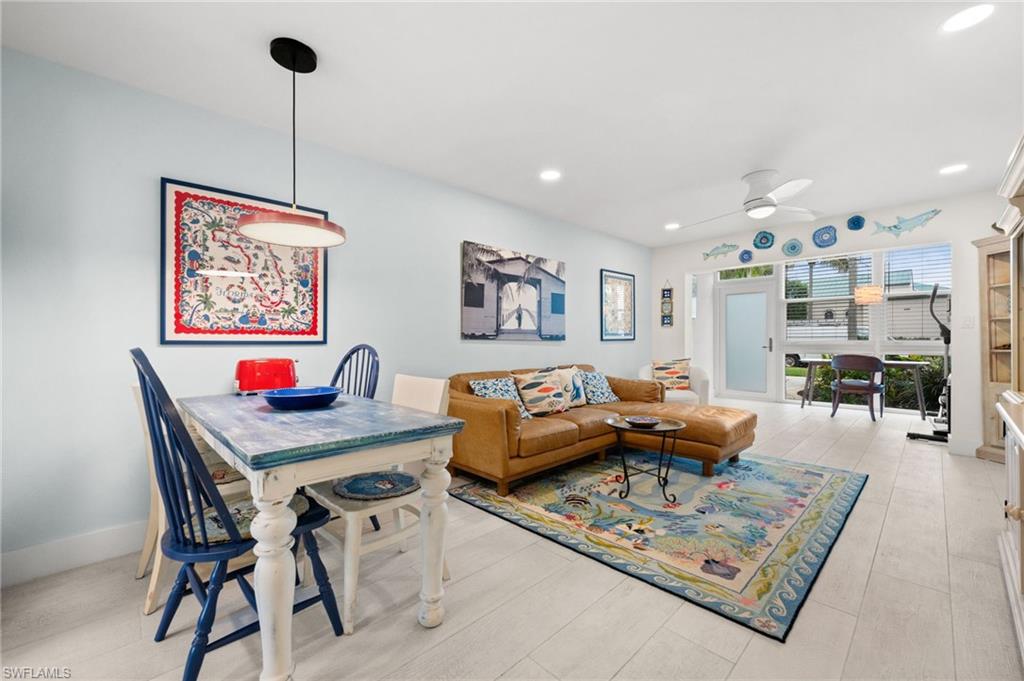 1021 3rd Street South, Unit 112 Naples, FL 34102 - Photo 24 of 27 a living room with furniture and a table