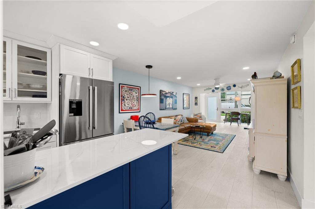 1021 3rd Street South, Unit 112 Naples, FL 34102 - Photo 25 of 27 a kitchen with refrigerator and cabinets