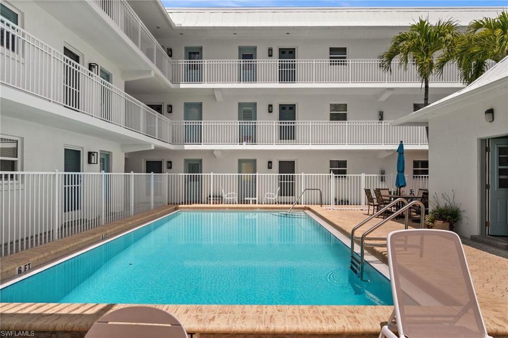 1021 3rd Street South, Unit 112 Naples, FL 34102 - Photo 27 of 27 a view of a house with backyard pool and sitting area