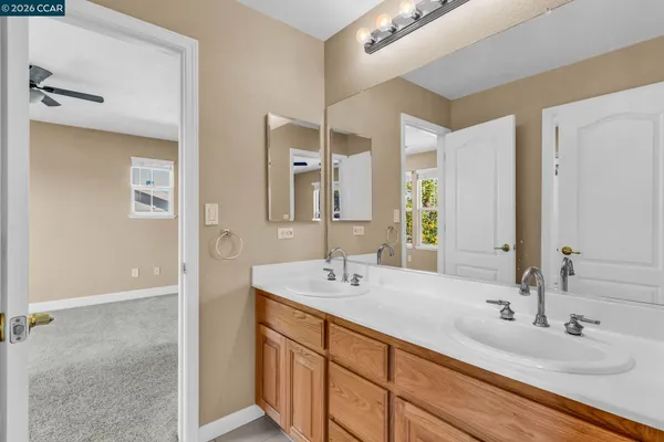 a bathroom with 2 sink and a mirror