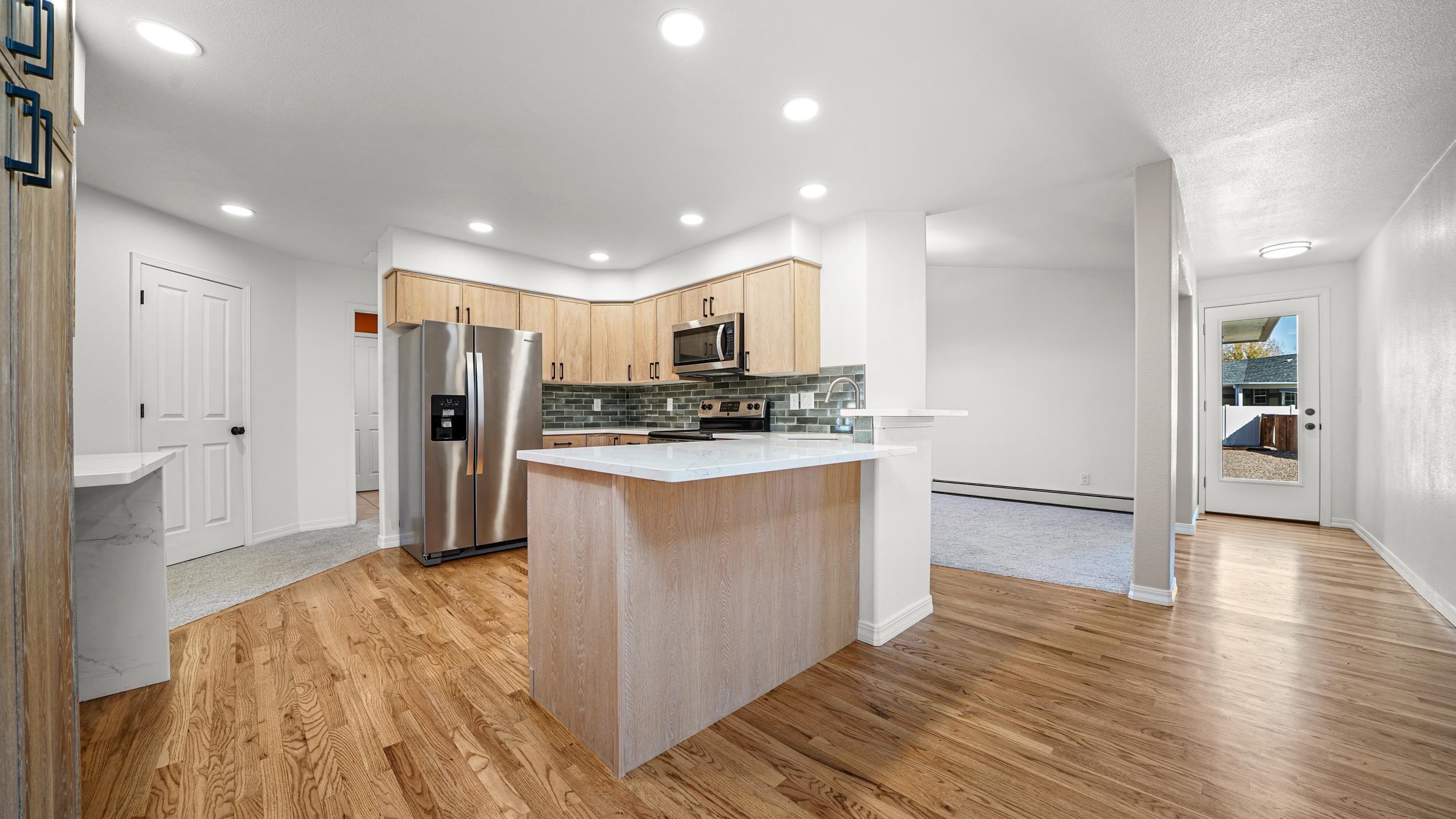 1631 Ptarmigan Ridge Court Grand Junction, CO 81506 - Photo 10 of 33 a kitchen with stainless steel appliances a refrigerator and wooden floor