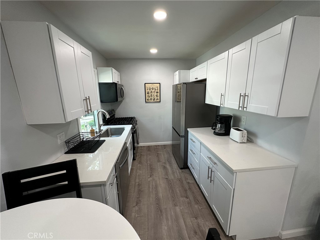 239 3rd Avenue Venice, CA 90291 - Photo 2 of 10 a kitchen with a sink a stove and cabinets