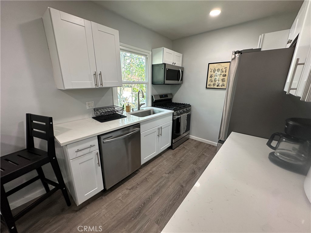 239 3rd Avenue Venice, CA 90291 - Photo 8 of 10 a view of a kitchen with sink dishwasher and wooden floor