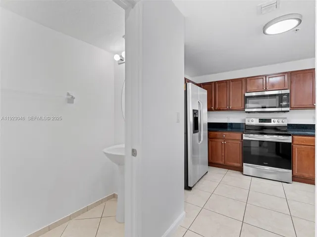 a kitchen with stainless steel appliances a stove a microwave and a refrigerator