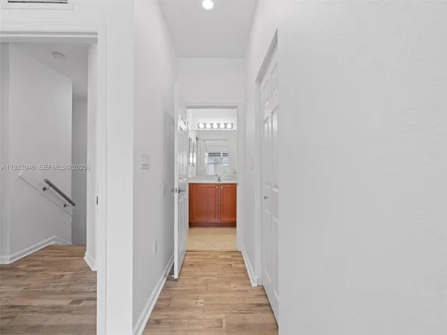 a view of a hallway with wooden floor