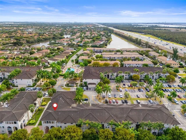 an aerial view of residential houses with outdoor space and ocean view