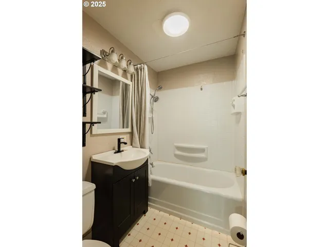 a bathroom with a sink a mirror and a bathtub