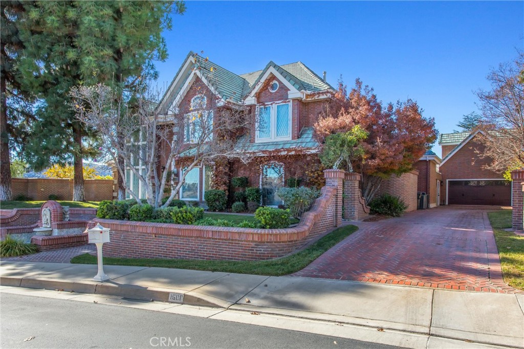 1608 Smiley Ridge Redlands, CA 92373 - Photo 6 of 84 a front view of a house with a yard and potted plants