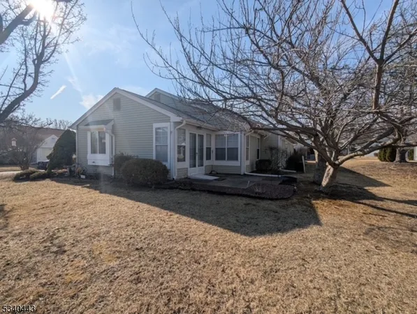 a front view of a house with yard covered in snow