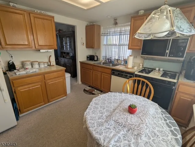 a kitchen with a sink a stove and a microwave