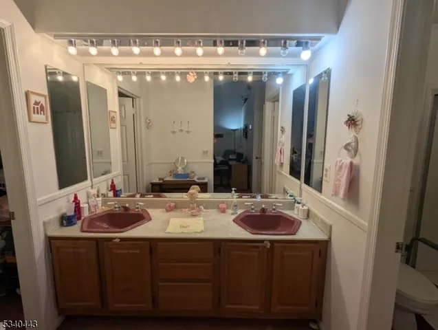a bathroom with a double vanity sink and a mirror