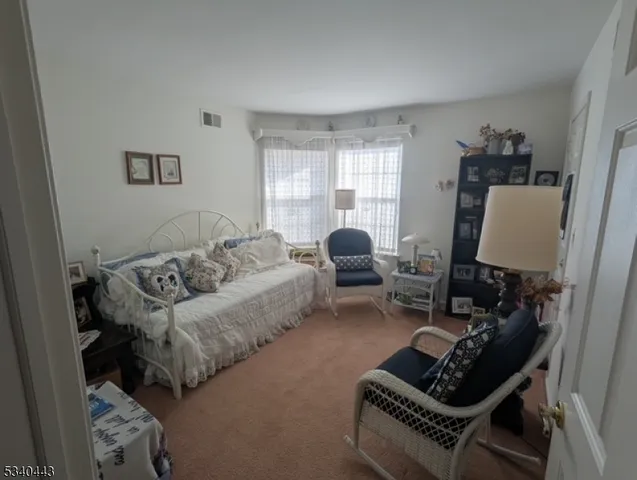 a living room with furniture a couch and a window