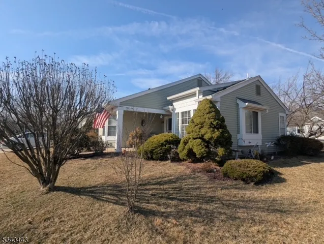 a view of a house with a yard covered in snow
