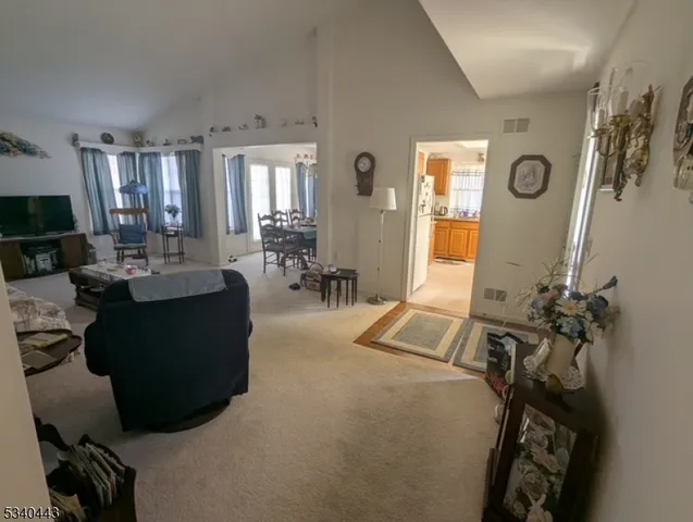 a living room with furniture gym equipment and a large window