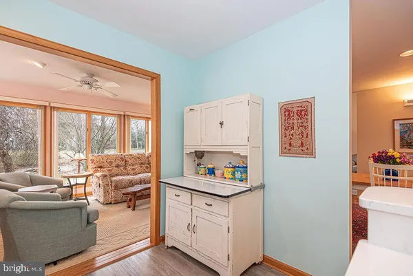 a view of entryway and hall with wooden floor