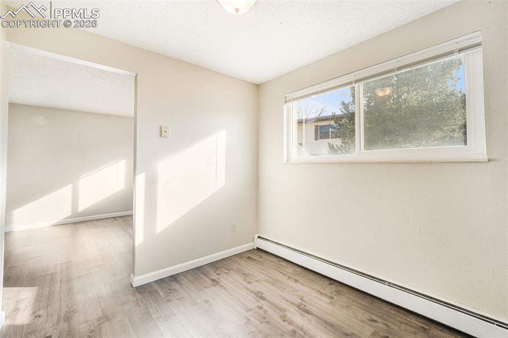 6610 Dublin Loop West, Unit 2 Colorado Springs, CO 80918 - Photo 14 of 50 a view of an empty room with wooden floor and a window
