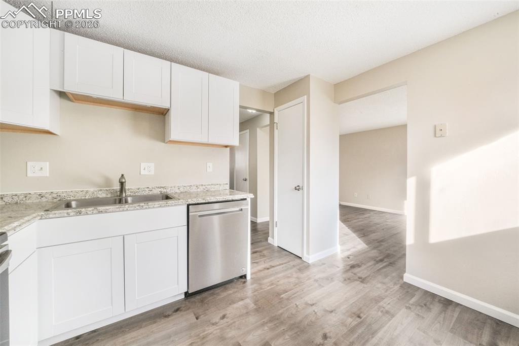 6610 Dublin Loop West, Unit 2 Colorado Springs, CO 80918 - Photo 15 of 50 a kitchen with a sink and cabinets
