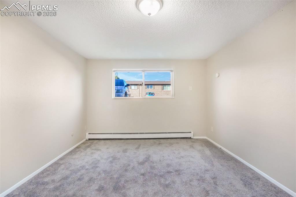 6610 Dublin Loop West, Unit 2 Colorado Springs, CO 80918 - Photo 16 of 50 an empty room with a empty space and windows