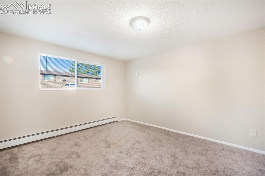 6610 Dublin Loop West, Unit 2 Colorado Springs, CO 80918 - Photo 22 of 50 an empty room with a workbench
