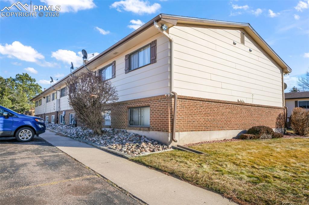 6610 Dublin Loop West, Unit 2 Colorado Springs, CO 80918 - Photo 42 of 50 a view of a house with a yard