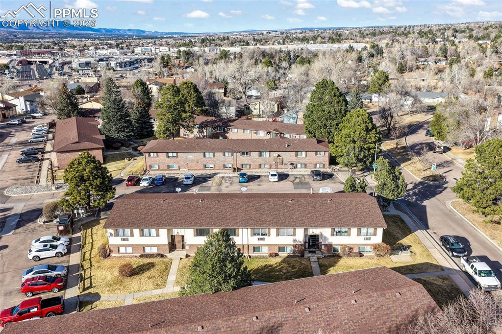 6610 Dublin Loop West, Unit 2 Colorado Springs, CO 80918 - Photo 46 of 50 an aerial view of a house with a yard and lake view