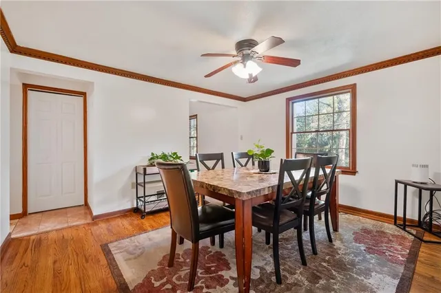 a view of a dining room with furniture and window