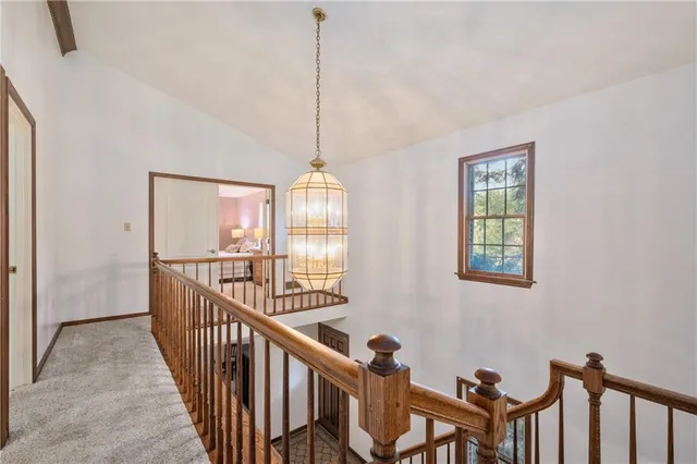 an empty room with windows and ceiling fan