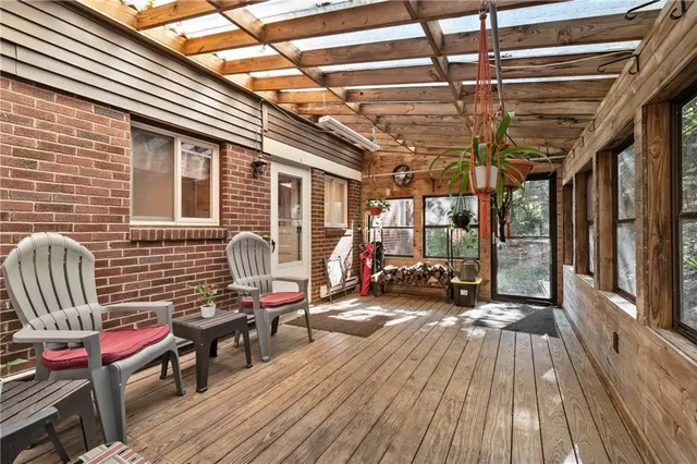 a view of a patio with table and chairs with wooden fence and plants