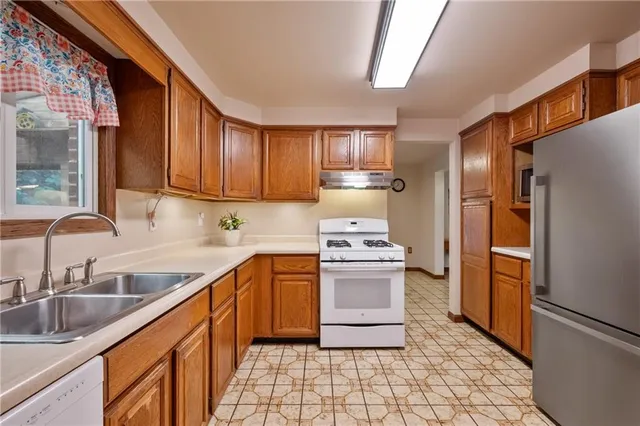 a kitchen with granite countertop a sink cabinets and window