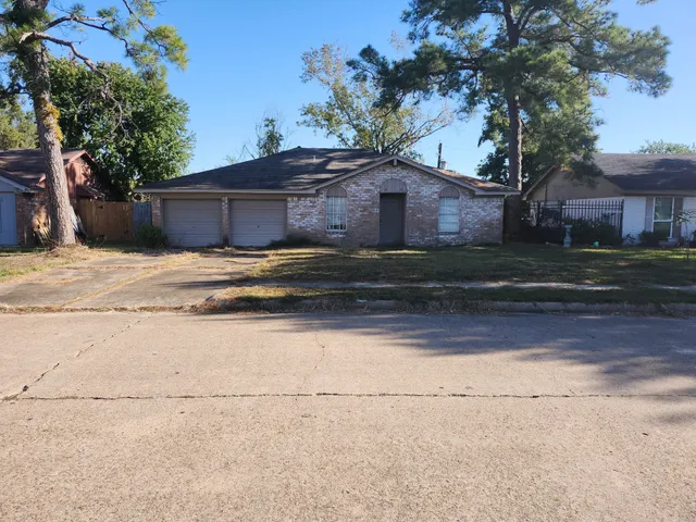 a house that has a tree in front of it