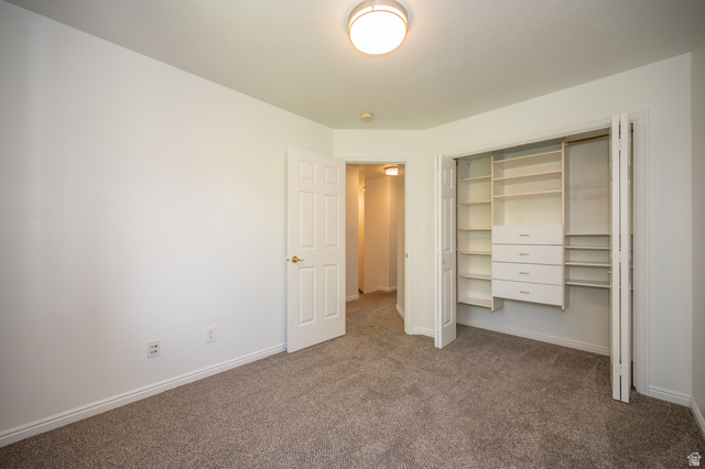 1799 West 1110th Street North Provo, UT 84604 - Photo 21 of 24 Bedroom featuring neutral carpeting, white walls, and a built-in closet organization system