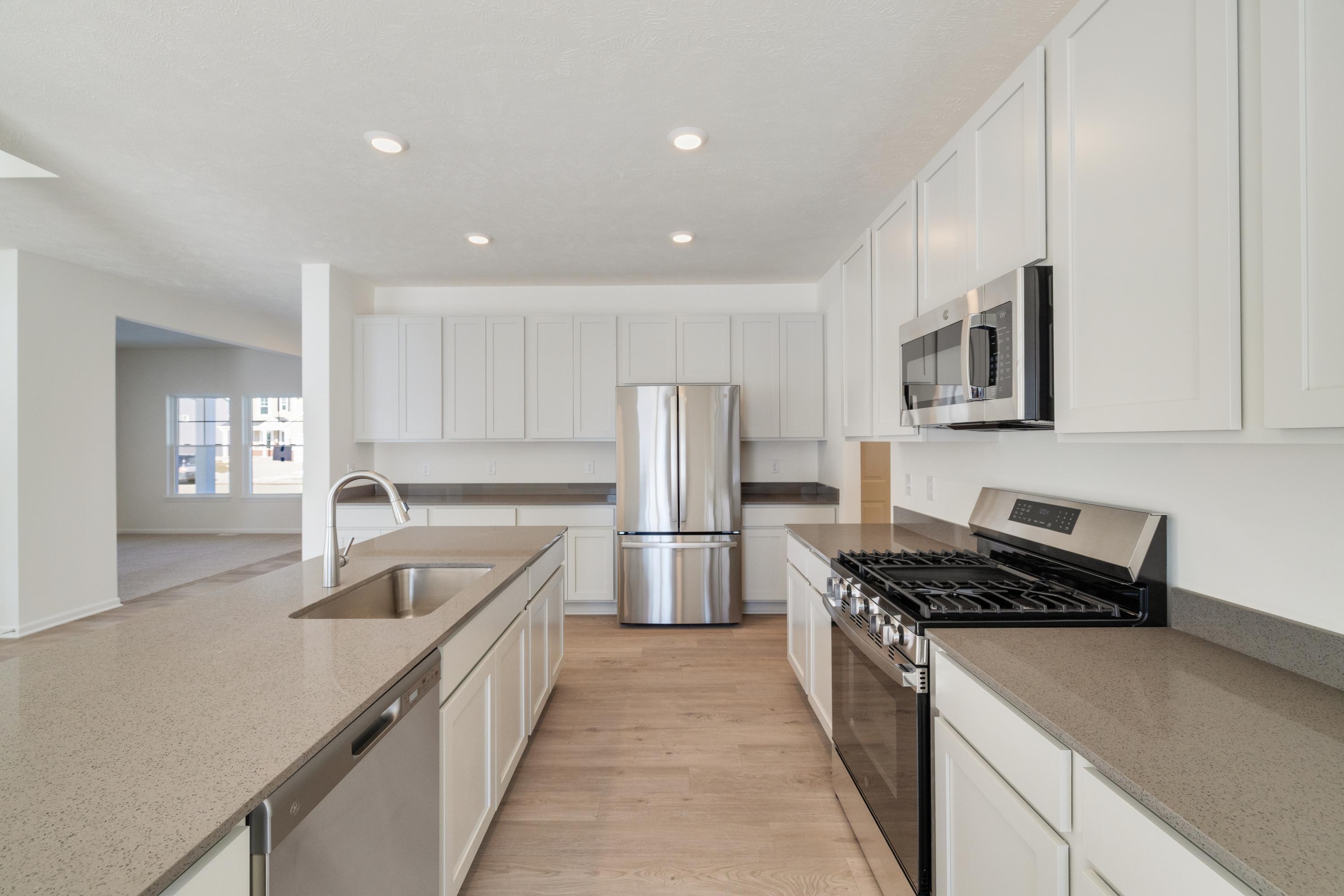 545 East 130th Place Crown Point, IN 46307 - Photo 11 of 25 a kitchen with stainless steel appliances sink stove microwave and cabinets