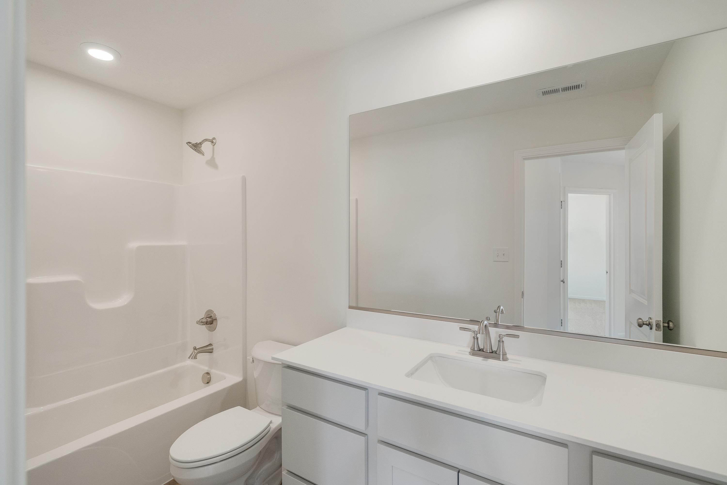 545 East 130th Place Crown Point, IN 46307 - Photo 21 of 25 a bathroom with a sink a toilet and bathtub