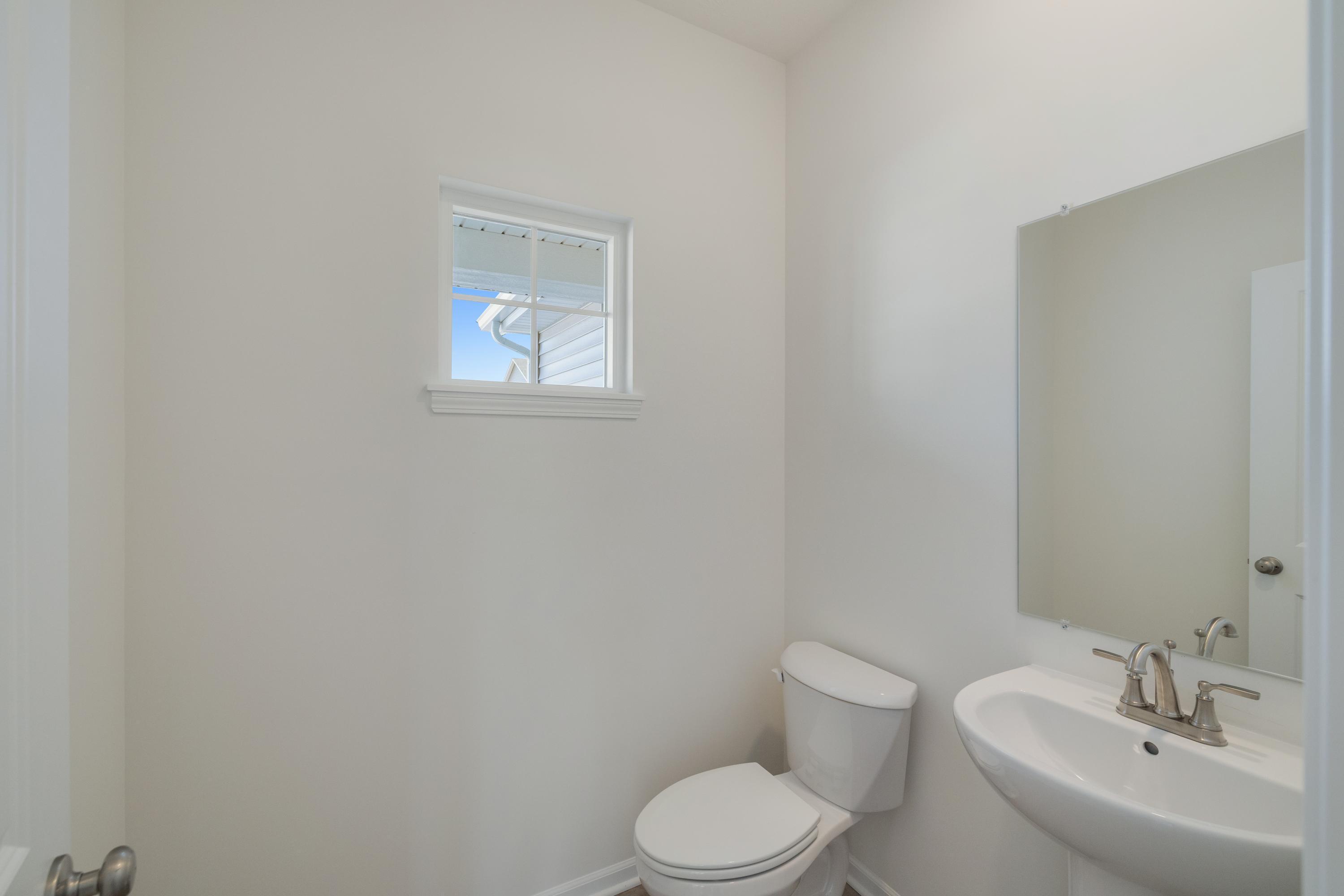 545 East 130th Place Crown Point, IN 46307 - Photo 6 of 25 a bathroom with a toilet a sink and mirror