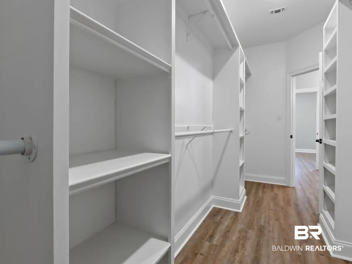 10174 Grady Lane Mobile, AL 36695 - Photo 11 of 14 Walk in closet featuring dark wood-style flooring