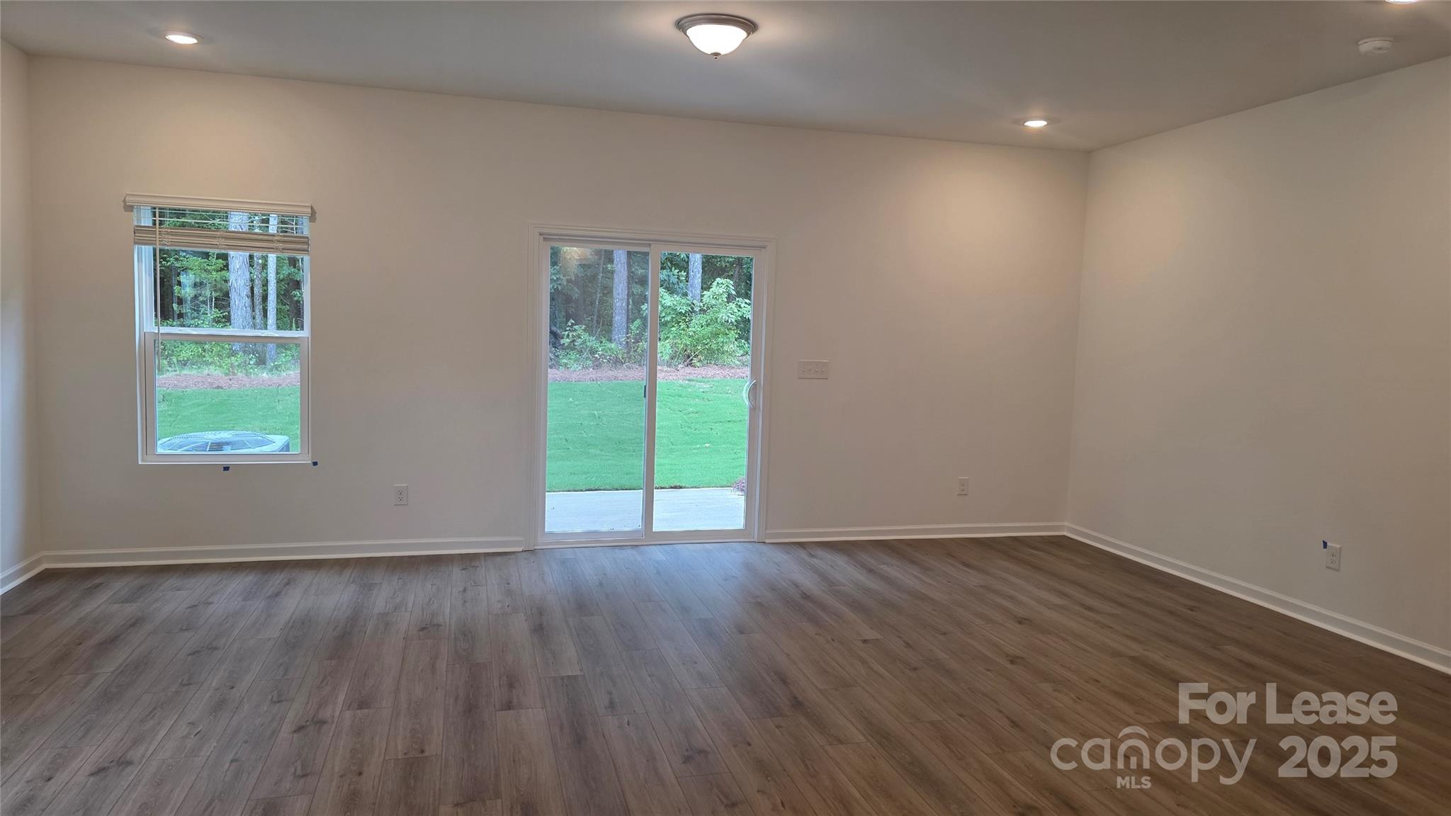 3516 Nimbell Road Monroe, NC 28110 - Photo 3 of 18 a view of an empty room with wooden floor and a window