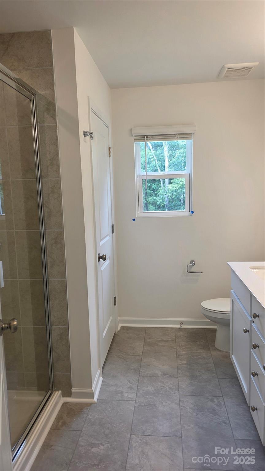 3516 Nimbell Road Monroe, NC 28110 - Photo 9 of 18 a bathroom with a granite countertop sink a toilet and shower